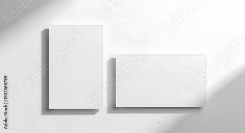 Elegant branding mockup featuring two blank white business cards, vertical and horizontal, with a soft shadow overlay for a modern presentation