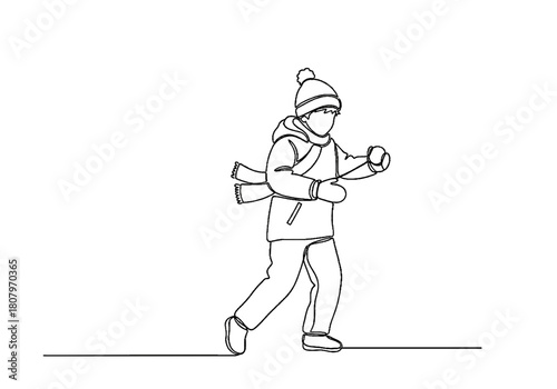 Boy running while preparing for snowball fight in winter scene  