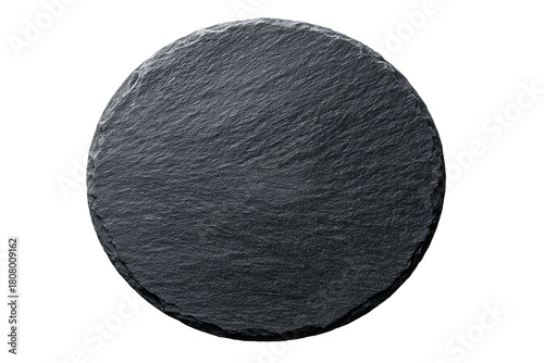 Close-up of a dark gray, circular slate slab.?Smooth,?textured surface.?Isolated on black background