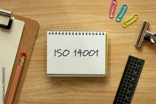 There is notebook with the word ISO 14001. It is as an eye-catching image.