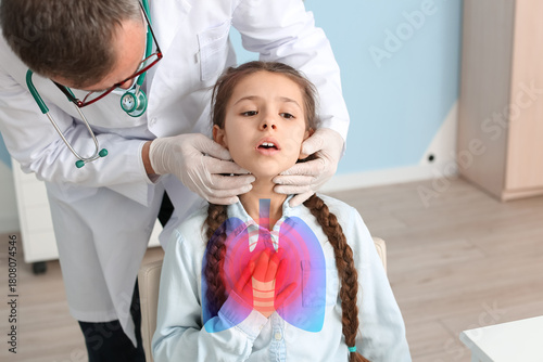 Doctor examining little gir...