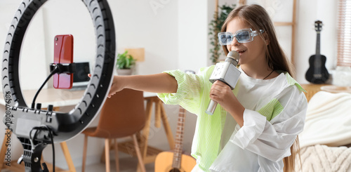 Singing little girl with mi...