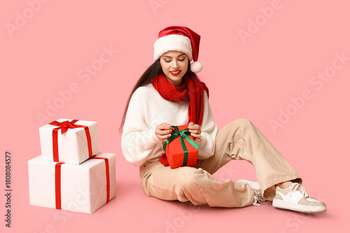 Young woman in santa hat an...