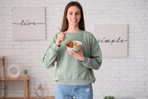 Young woman with bowl of sa...