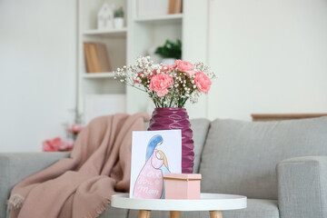 Vase with flowers, card for Mother's Day and gift on table in living room