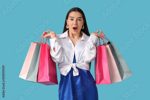 Excited young woman holding...