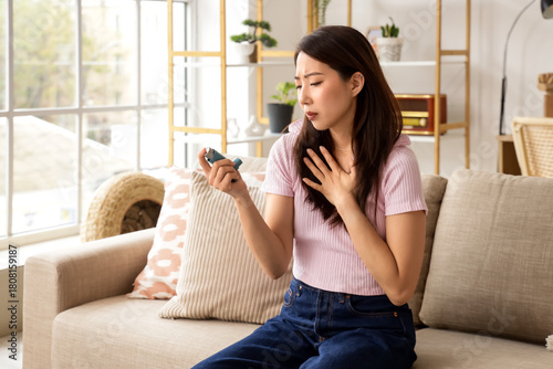 Young Asian woman with inha...