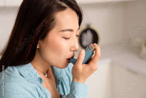 Young Asian woman using inh...