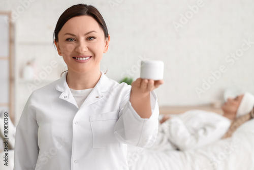 Female beautician with jar ...