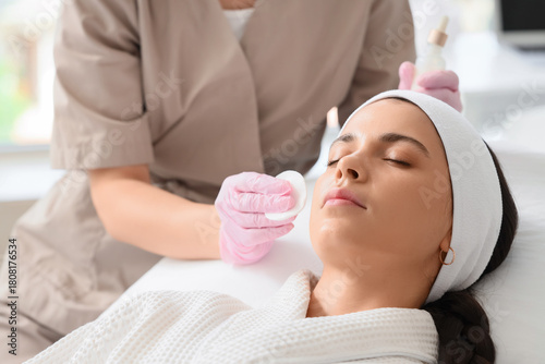 Beautician applying serum o...