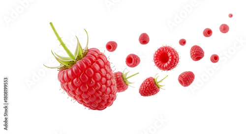 Fresh ripe raspberries in a dynamic splash, with one large detailed berry and smaller pieces flying in the air, isolated on a white background
