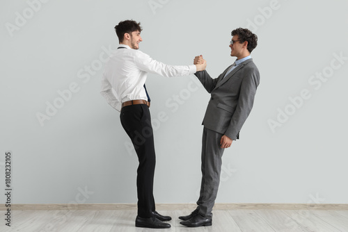 Young brothers in suits hol...