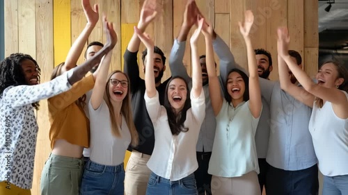Diverse Group of Young Business Professionals Cheering and Celebrating Success with Raised Hands