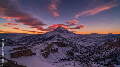 Snow-covered mountain landscape at sunset in winter travel  
