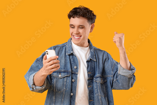 Happy young man with mobile...