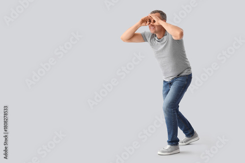 Mature man looking through ...