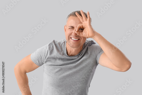 Mature man looking through ...
