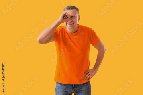 Mature man looking through ...