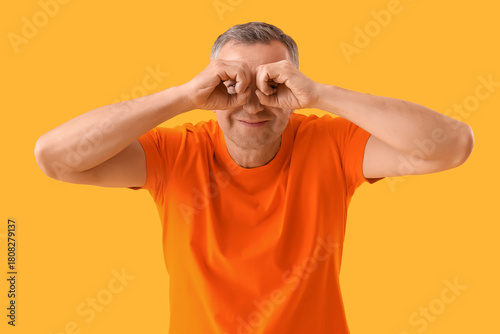 Mature man looking through ...
