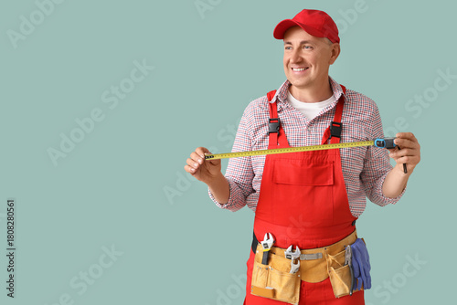 Male worker with tape measu...