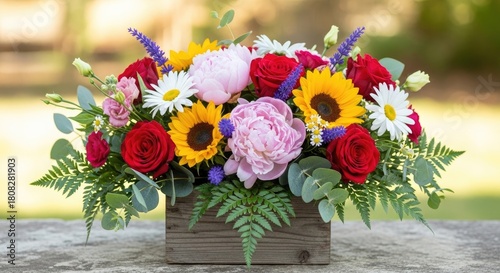 Fototapeta Naklejka Na Ścianę i Meble -  A vibrant flower arrangement with sunflowers, daisies, and peonies in a wooden box on a stone surface.