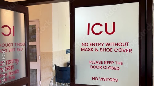 hospital icu entrance with safety instructions on glass door