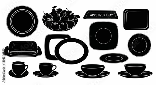 Black and white tableware and fruit bowl arrangement for dining.