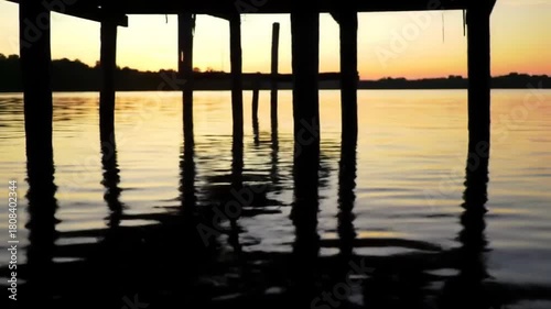 Wallpaper Mural Serene Sunset Pier Reflection on Water with Golden Hues and Shadow Play Torontodigital.ca