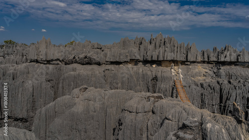 Photos A rickety suspension bridge spans over a gorge between rocks