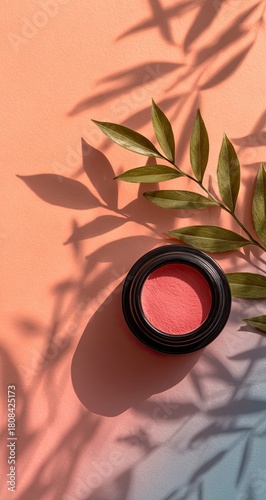 Pink blush with foliage shadows on peachy backdrop, overhead view