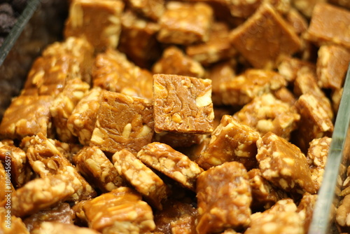 Traditional jaggery gurr and peanut sweet gajak showing Indian winter confection mixture