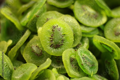 Dried green kiwi fruit slices close up showing dehydrated fruit texture and detail