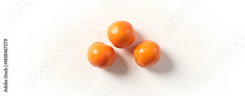 Three vibrant orange plums on a white background  