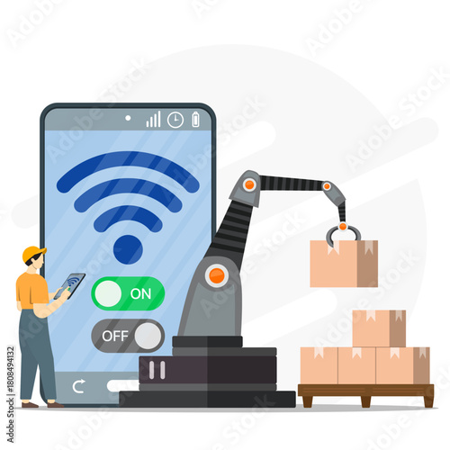 A worker using smartphone to activating digitally robotic arms to moving boxes of goods to be stacked on pallets. Modern industry to inventory management.