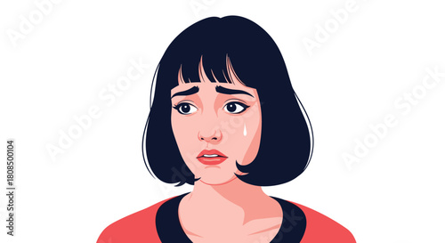 Sad young woman with dark bob haircut crying with a tear on her cheek.