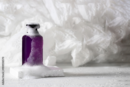 Shampoo, facial cleanser, bath gel product for face, body or hair care. Cosmetic bottle with white foam on the podium,