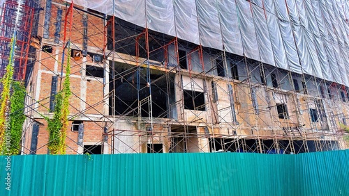 Building Construction Site with Scaffolding and Brick Structure, Hospital under construction