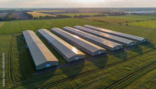 Aerial view of a modern agricultural complex with long farm buildings.