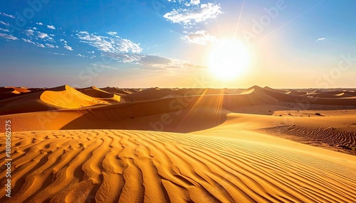 Fototapeta Naklejka Na Ścianę i Meble -  Vast desert landscape with rolling sand dunes illuminated by the bright sun, casting long shadows and highlighting the rippled texture of the sand.