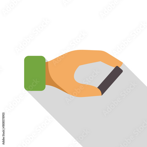 Hand holding a small dark gray rectangular object, possibly a battery or electronic component, casting a long shadow