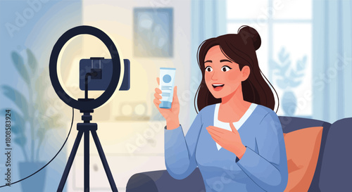 Young woman influencer live streaming a beauty product review with her phone and a ring light from her cozy home studio setup
