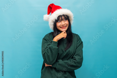 Asian woman smiles softly resting her chin with a cozy pose Ideal for warm Christmas greetings and lifestyle visuals