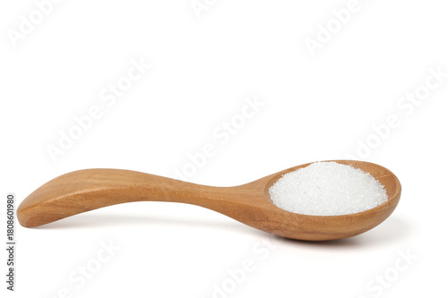 White granulated sugar in a wooden spoon. isolated on a white background.