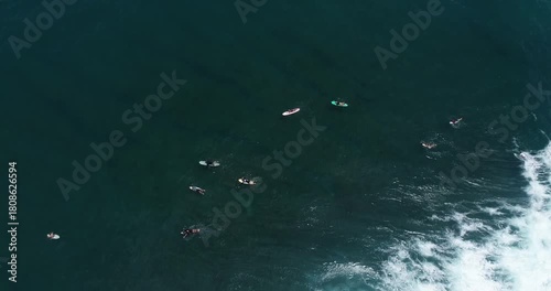 Surfers on the sea surface with surging waves.