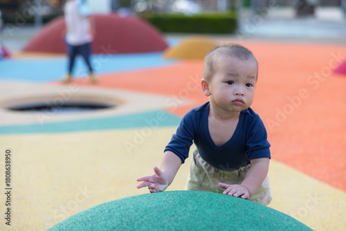 Toddler having fun playing at vibrant park outdoors