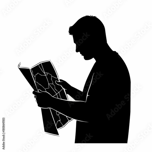 Silhouette of a man studying a map.