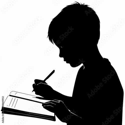 Silhouette of a young boy diligently writing in a notebook.