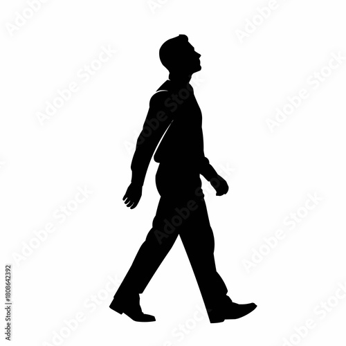 Silhouette of a man walking confidently forward looking up.