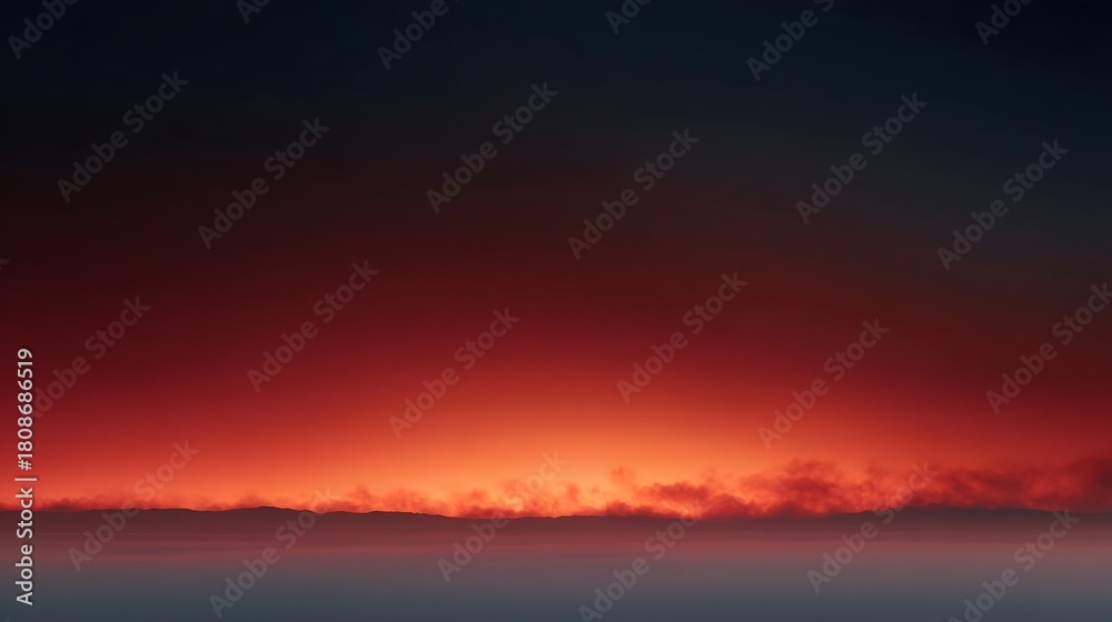 Obraz premium Dramatic sunset horizon glowing with vibrant red and orange hues with atmospheric clouds below