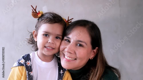 Latin mother and child having tender moment during Christmas time. Family love relationship